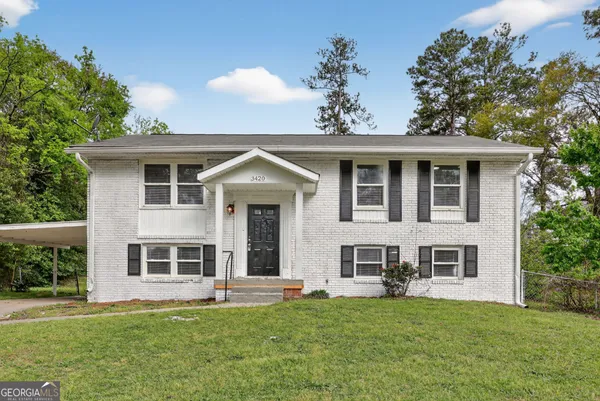 a front view of a house with a garden