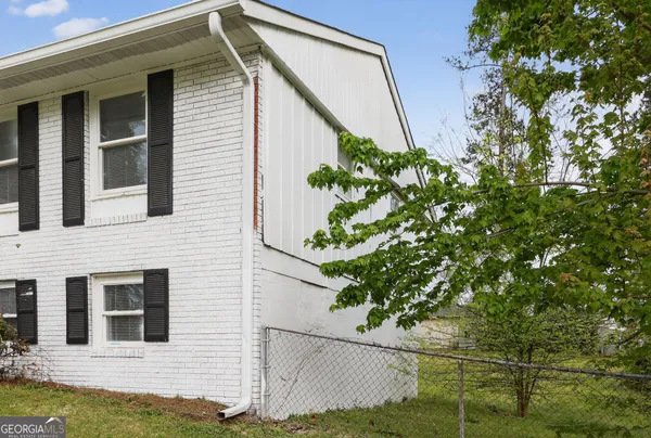 a house that has a tree in front of the house