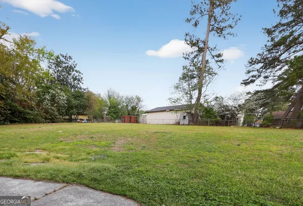 a view of a field with an trees