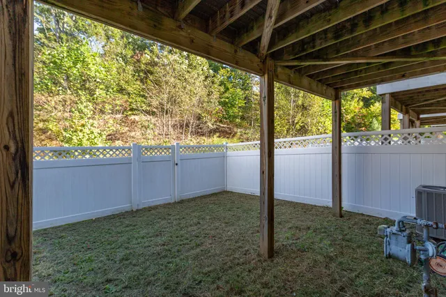 a view of a house with a yard and deck