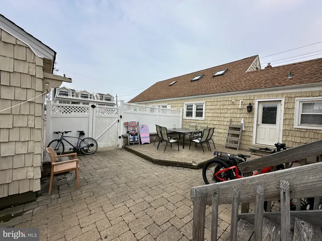 a view of a patio with table and chairs