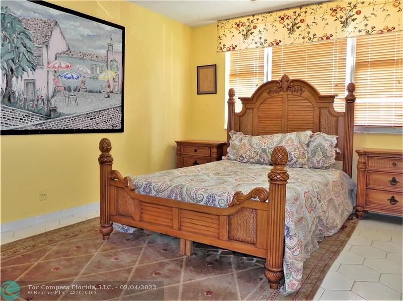 4350 Hillcrest Drive, Unit 212 Hollywood, FL 33021 - Photo 15 of 38 a bedroom with a bed and a painting on the wall