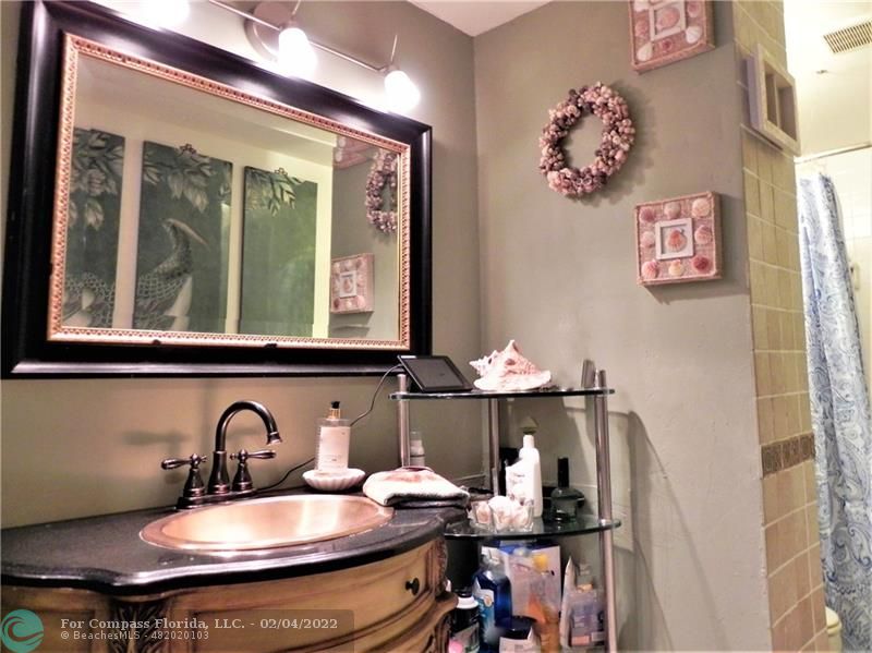 4350 Hillcrest Drive, Unit 212 Hollywood, FL 33021 - Photo 19 of 38 a bathroom with a sink and a mirror