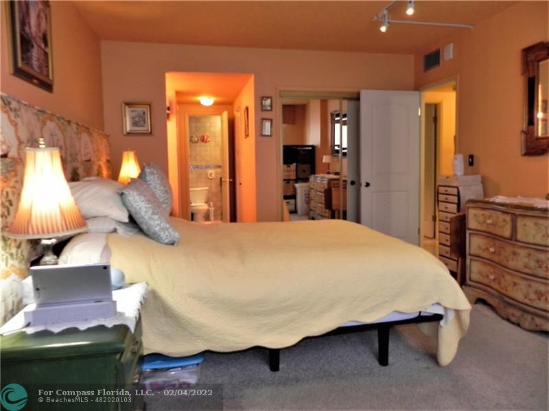 4350 Hillcrest Drive, Unit 212 Hollywood, FL 33021 - Photo 24 of 38 a bed room with a bed and a lamp