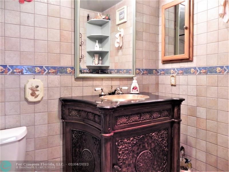 4350 Hillcrest Drive, Unit 212 Hollywood, FL 33021 - Photo 28 of 38 a bathroom with a sink and a mirror