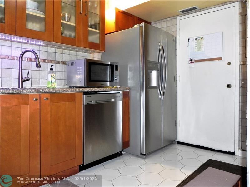 4350 Hillcrest Drive, Unit 212 Hollywood, FL 33021 - Photo 7 of 38 a kitchen with stainless steel appliances granite countertop a refrigerator and a stove
