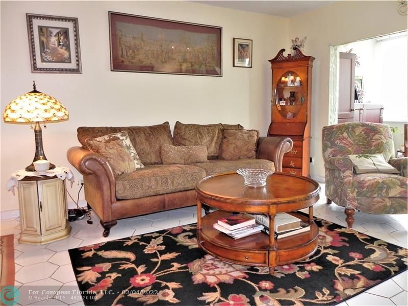 4350 Hillcrest Drive, Unit 212 Hollywood, FL 33021 - Photo 9 of 38 a living room with furniture and a rug