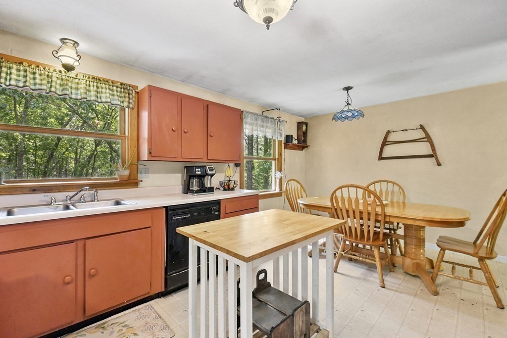 9 Number 6 Road Leverett, MA 01054 - Photo 4 of 26 a kitchen with stainless steel appliances granite countertop a table chairs sink and wooden cabinets