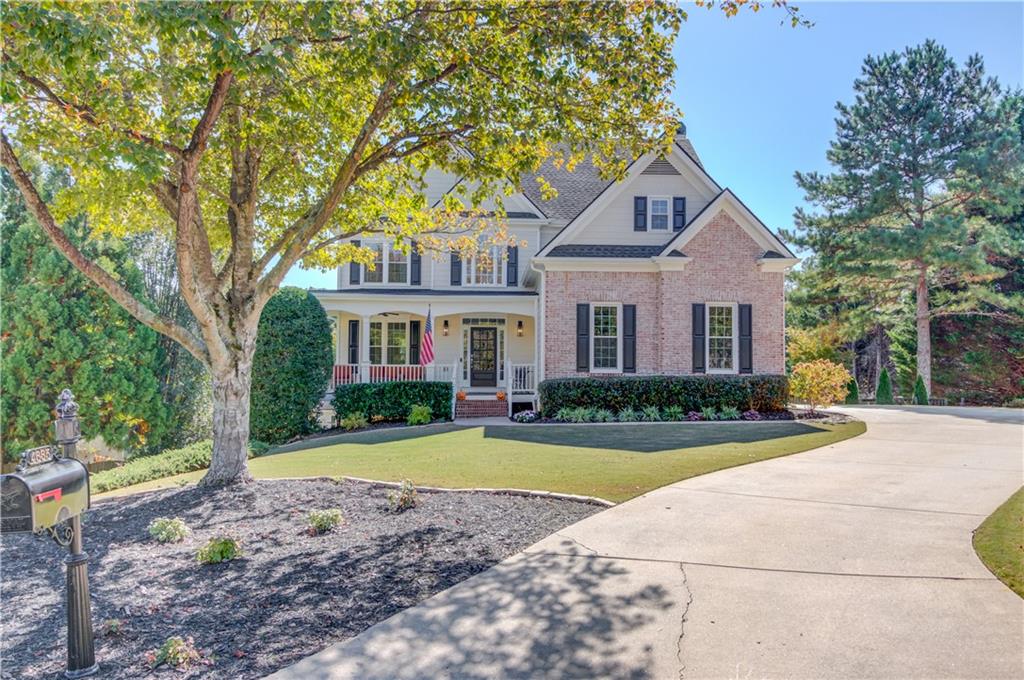 a front view of a house with yard and green space