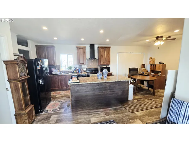 a room with furniture and a view of kitchen