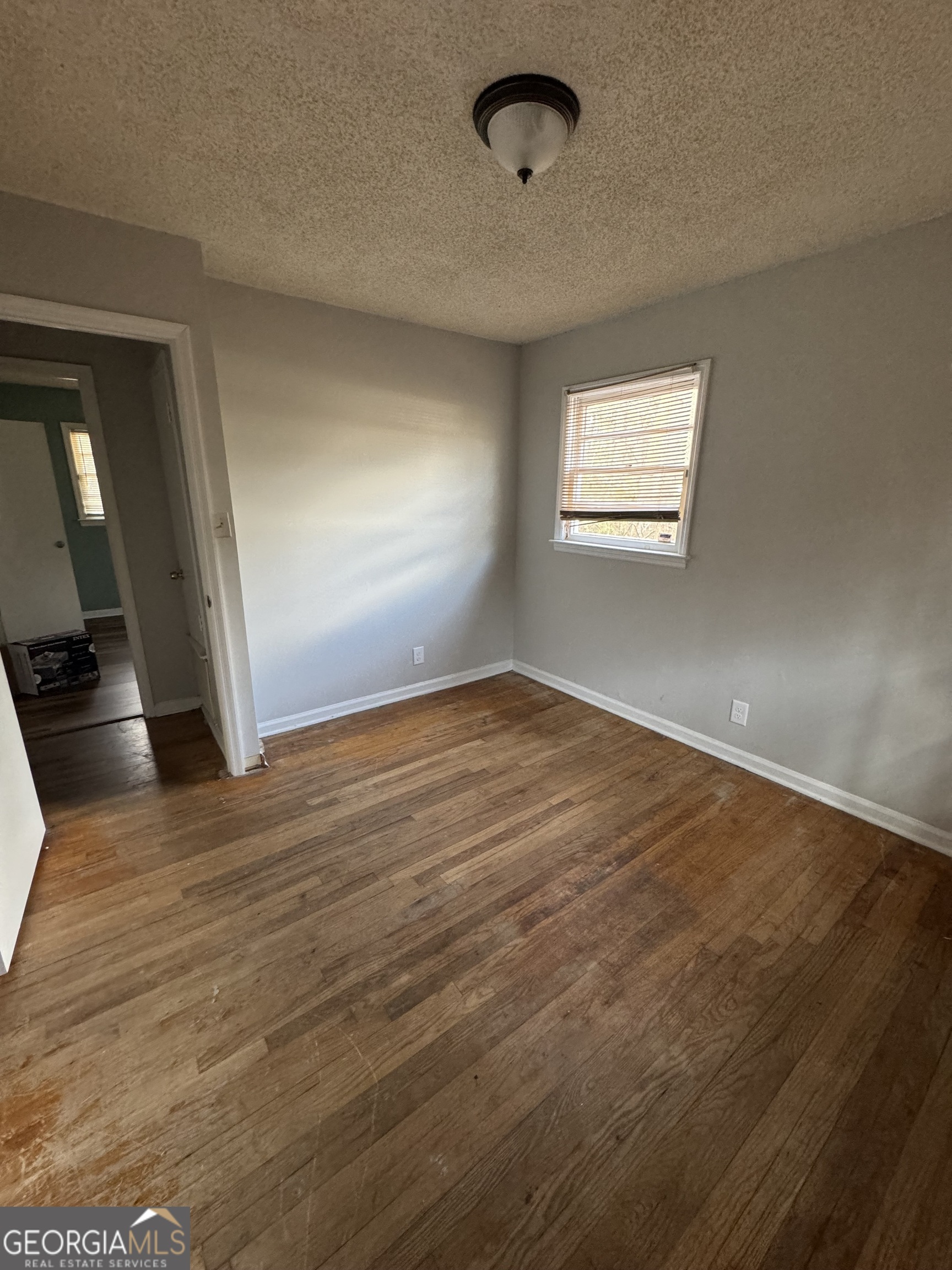 4367 Pharr Avenue Macon, GA 31210 - Photo 11 of 12 an empty room with wooden floor and windows