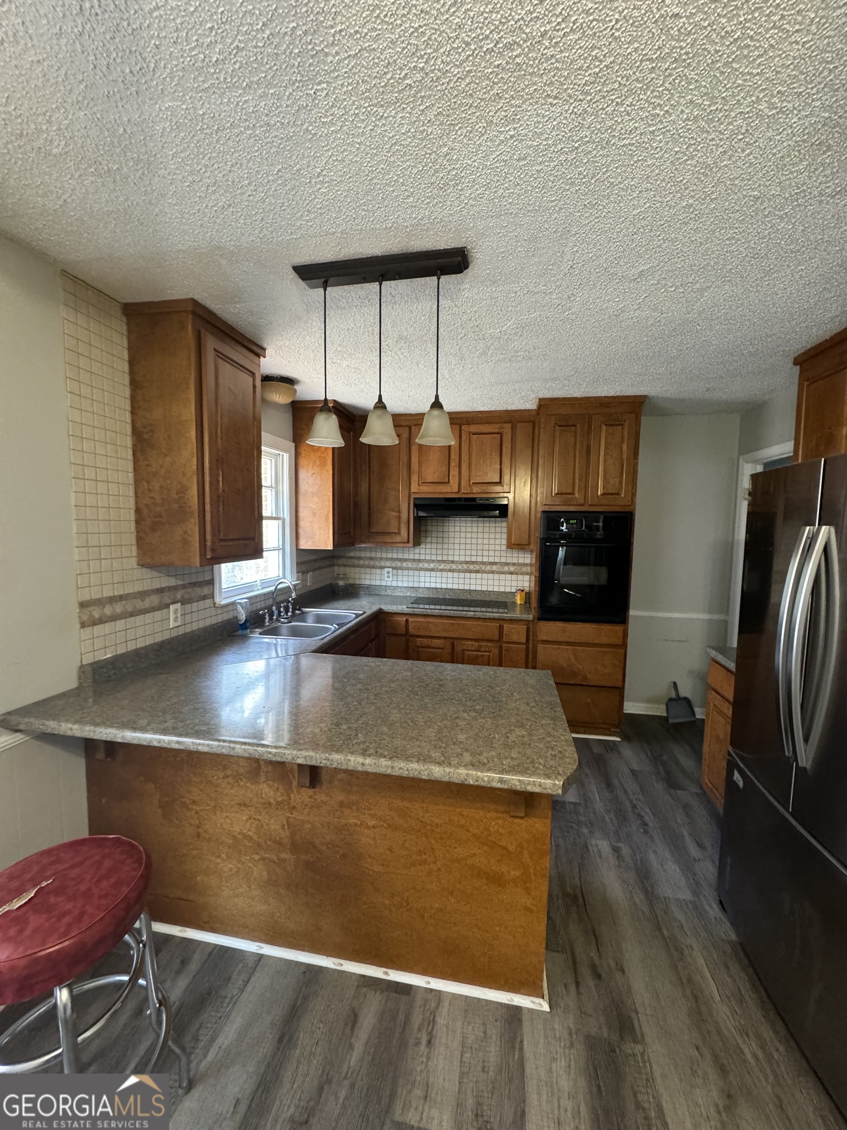 4367 Pharr Avenue Macon, GA 31210 - Photo 4 of 12 a kitchen with kitchen island granite countertop a sink and a refrigerator