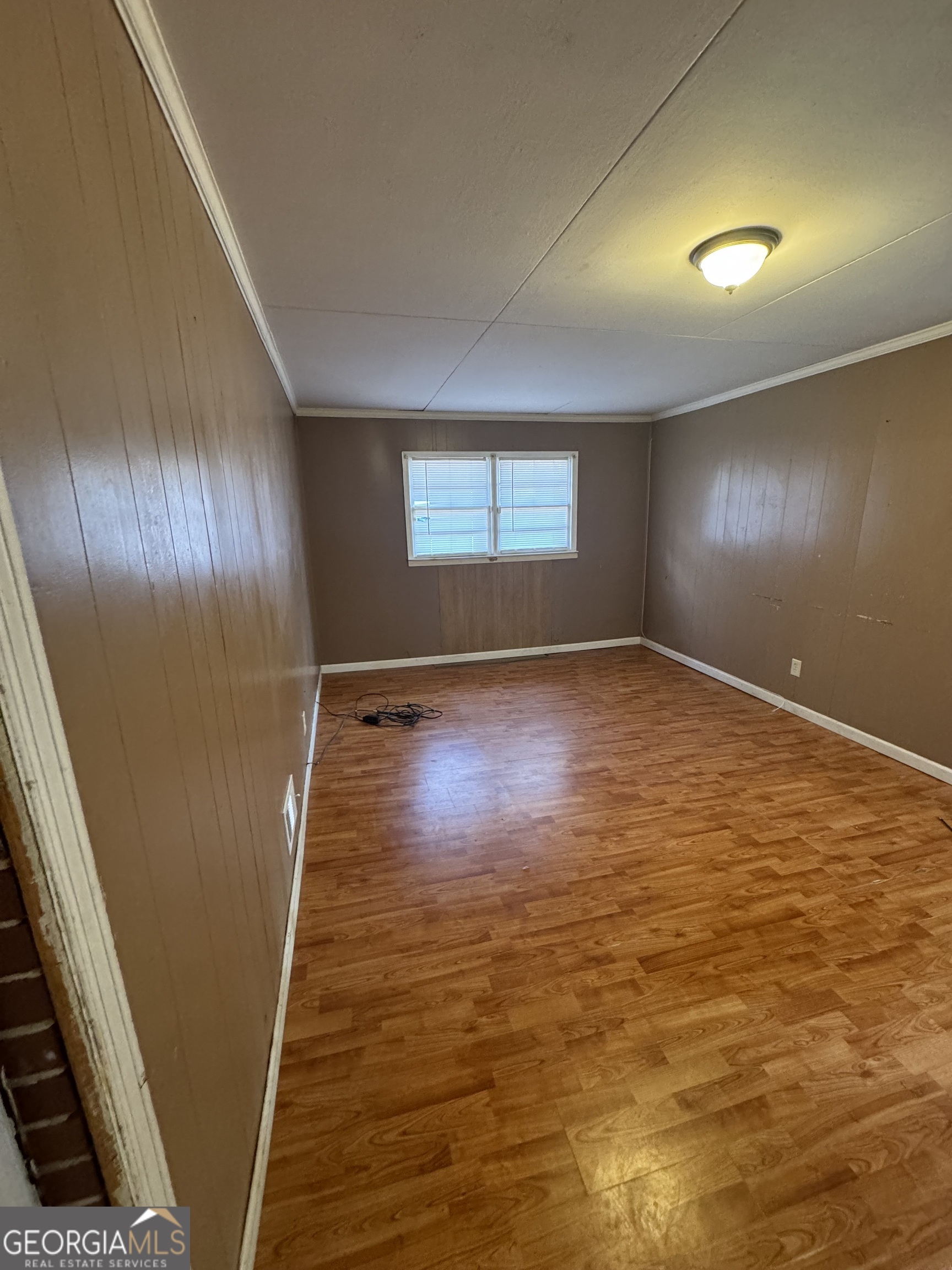 4367 Pharr Avenue Macon, GA 31210 - Photo 7 of 12 an empty room with wooden floor and windows