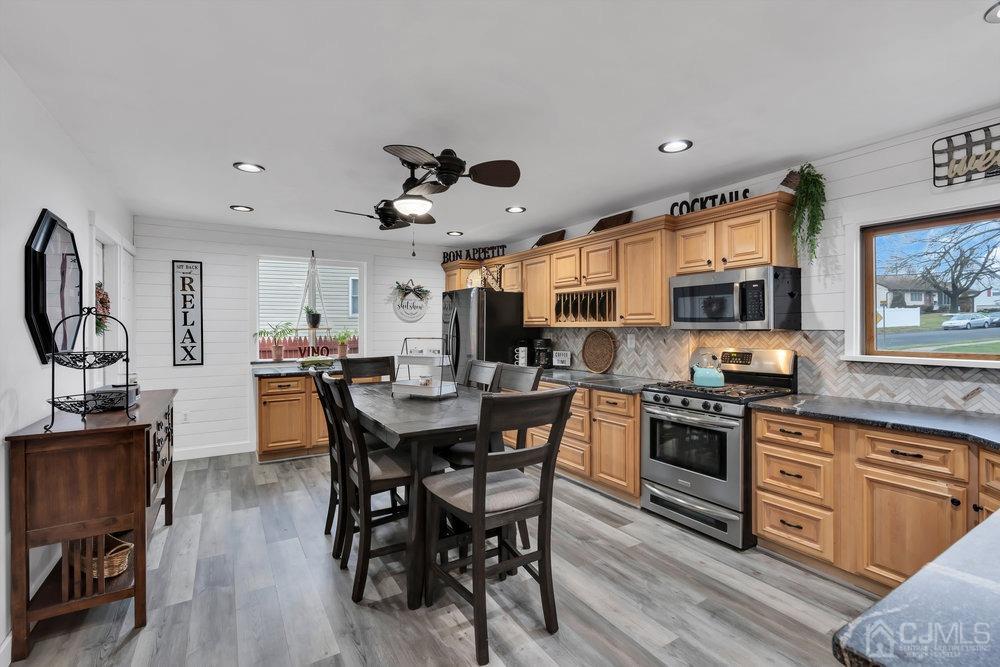 28 Ridgeview Road Jamesburg, NJ 08831 - Photo 13 of 46 Kitchen was redesigned and is not only large but it is absolutely stunning. New granite counters and beautiful backspash, shiplap back wall, and that FAN! It's amazing. The vinyl floors were recently installed.