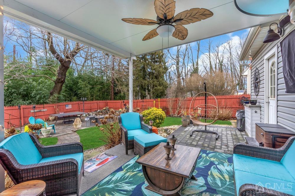 28 Ridgeview Road Jamesburg, NJ 08831 - Photo 33 of 46 The backyard if phenomenal! Everything you need to entertain. This is your view when you step out your slider. A double tiered deck which leads to a Belgium block patio. The permanent insulated awning has electricity, and 2 fans and a TV hung on the back wall!