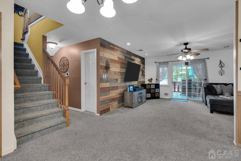 View of Living Room from Foyer - Amazing Shiplap wall adds incredible character to this room.  Slider to the beautiful backyard is visible.