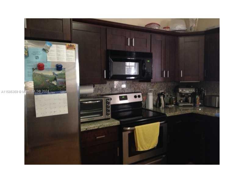 The Ridges Weston, FL 33331 - Photo 4 of 19 a kitchen with a sink a stove and refrigerator