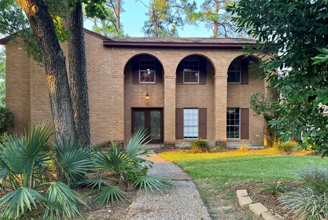 a front view of a house with garden