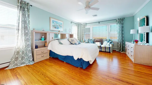 a bedroom with a bed and a wooden floor