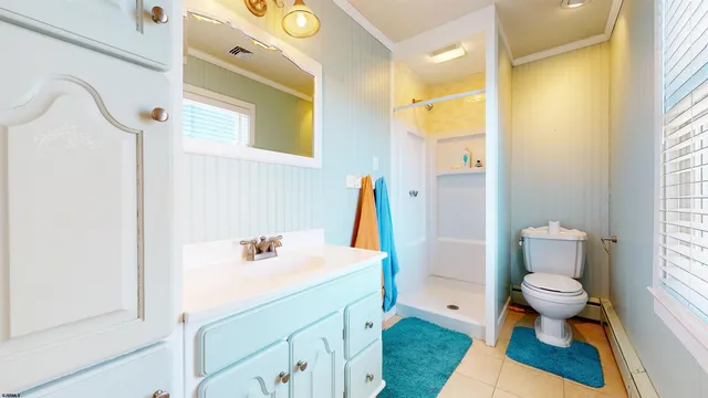 a bathroom with a sink a toilet and shower curtain