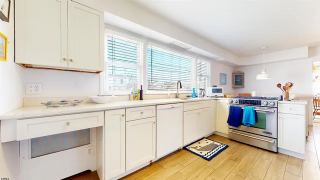 a kitchen with sink cabinets and window