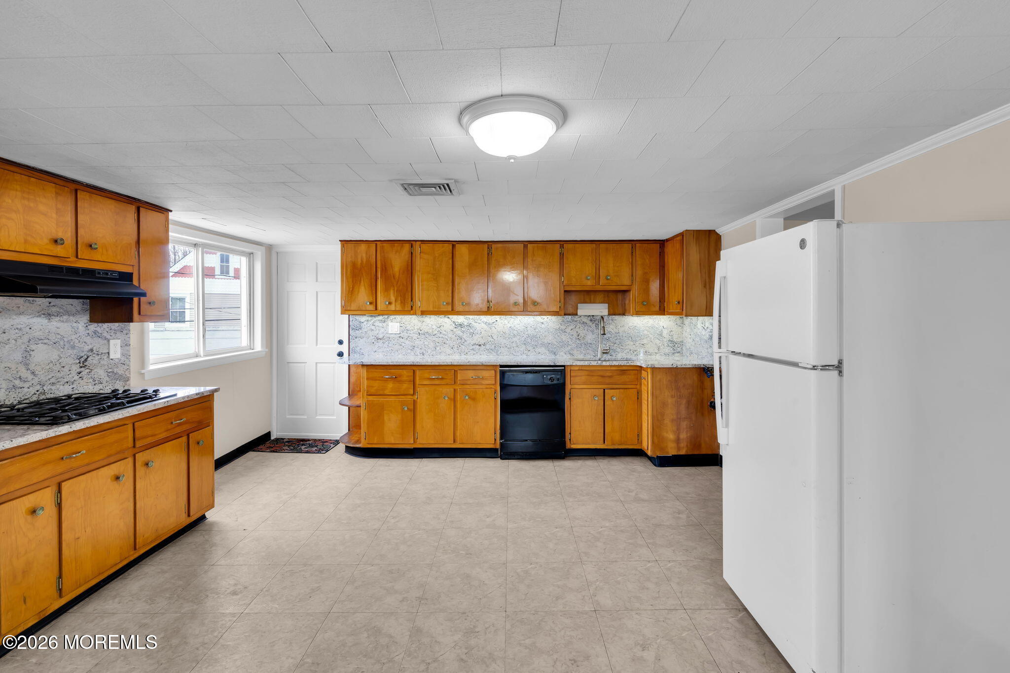 1001 Arnold Avenue Point Pleasant, NJ 08742 - Photo 6 of 14 a kitchen with granite countertop a sink and a refrigerator