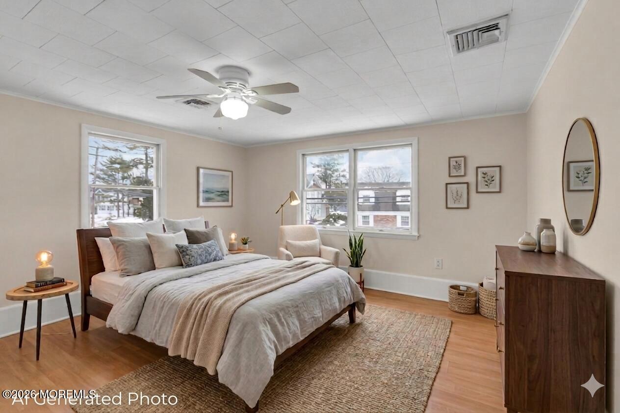 1001 Arnold Avenue Point Pleasant, NJ 08742 - Photo 7 of 14 a bedroom with a bed and a chandelier