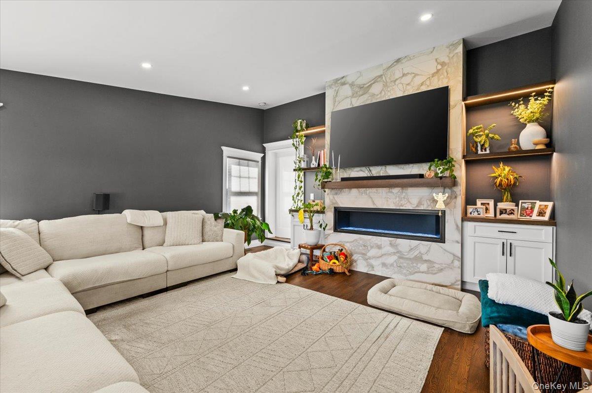 85 Joline Road Port Jefferson Station, NY 11776 - Photo 11 of 30 a living room with furniture and a flat screen tv