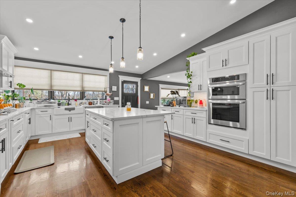 85 Joline Road Port Jefferson Station, NY 11776 - Photo 14 of 30 a kitchen with stainless steel appliances granite countertop a refrigerator oven a sink dishwasher and white cabinets with wooden floor