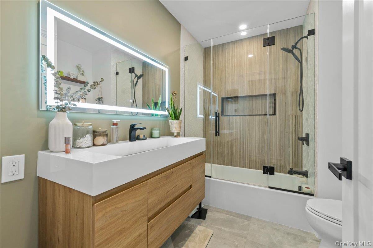 85 Joline Road Port Jefferson Station, NY 11776 - Photo 16 of 30 a bathroom with a sink a toilet a mirror and shower