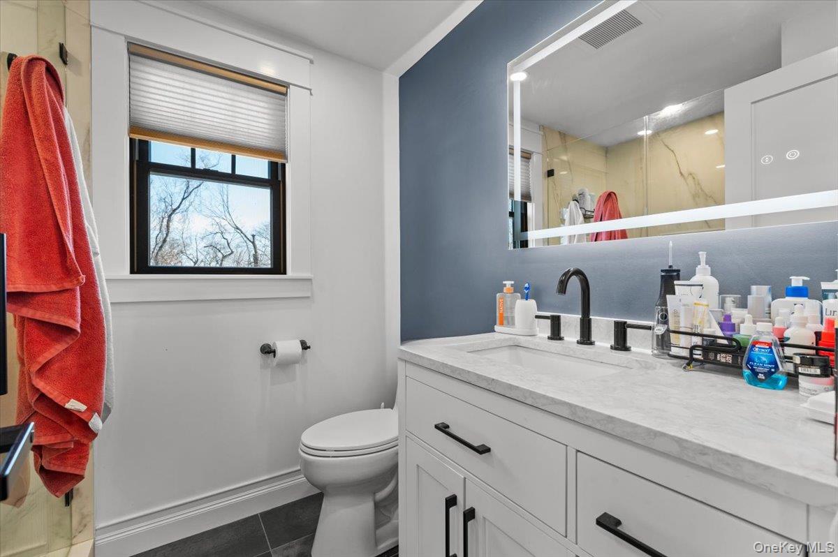 85 Joline Road Port Jefferson Station, NY 11776 - Photo 19 of 30 a bathroom with a sink a toilet and a mirror