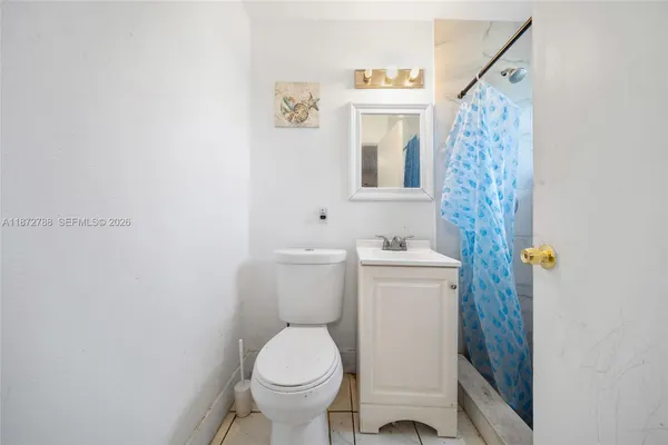 a white toilet sitting next to a bathroom sink