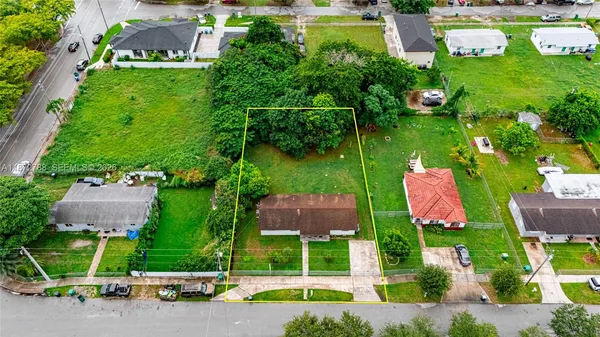 an aerial view of a house with garden space and outdoor seating