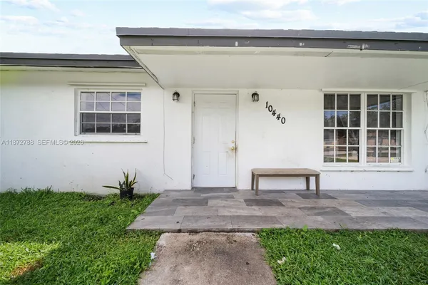 a bench sitting in front of a house