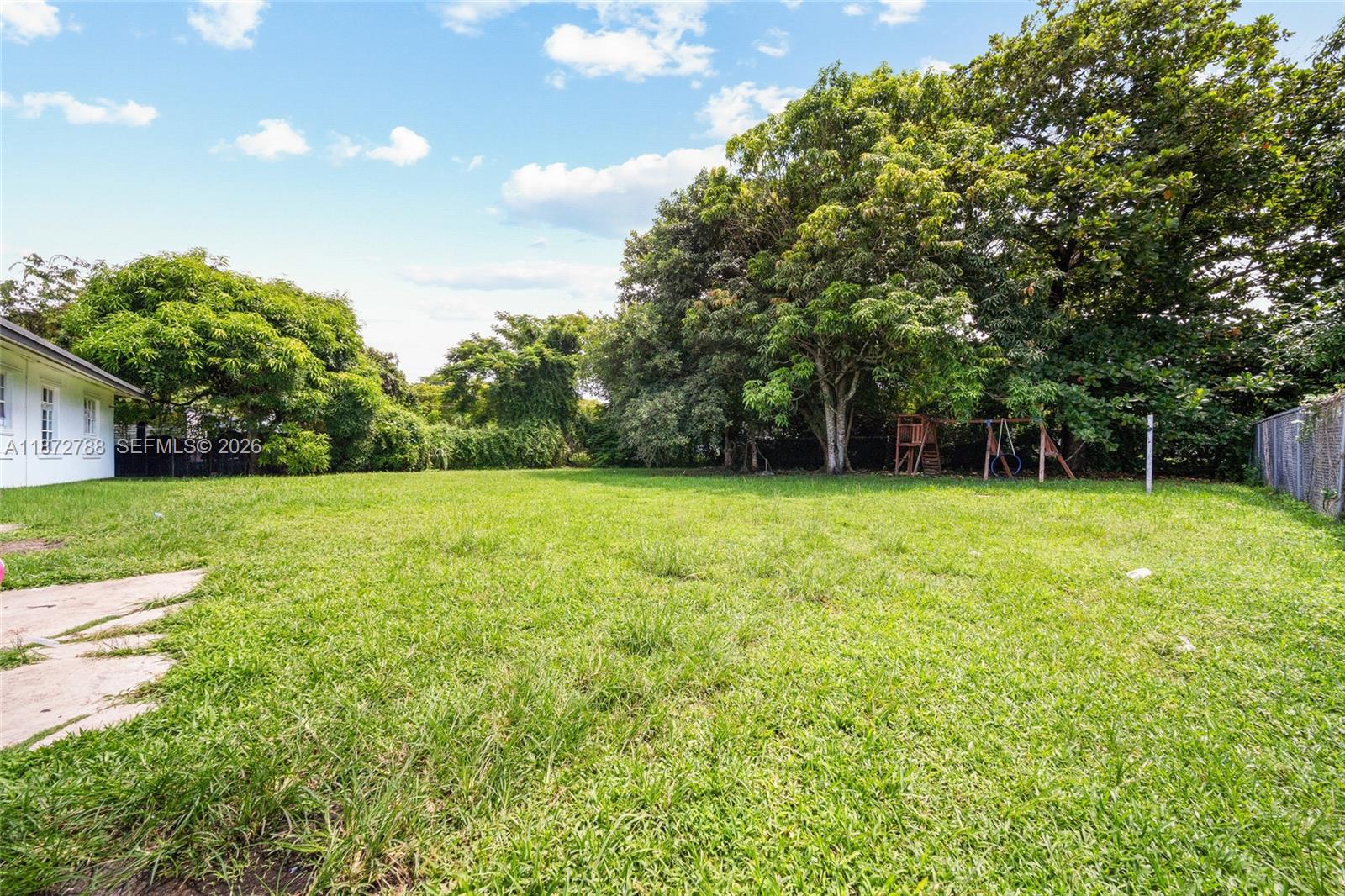 10440 Southwest 178th Street Miami, FL 33157 - Photo 26 of 30 a view of green field with trees in the background