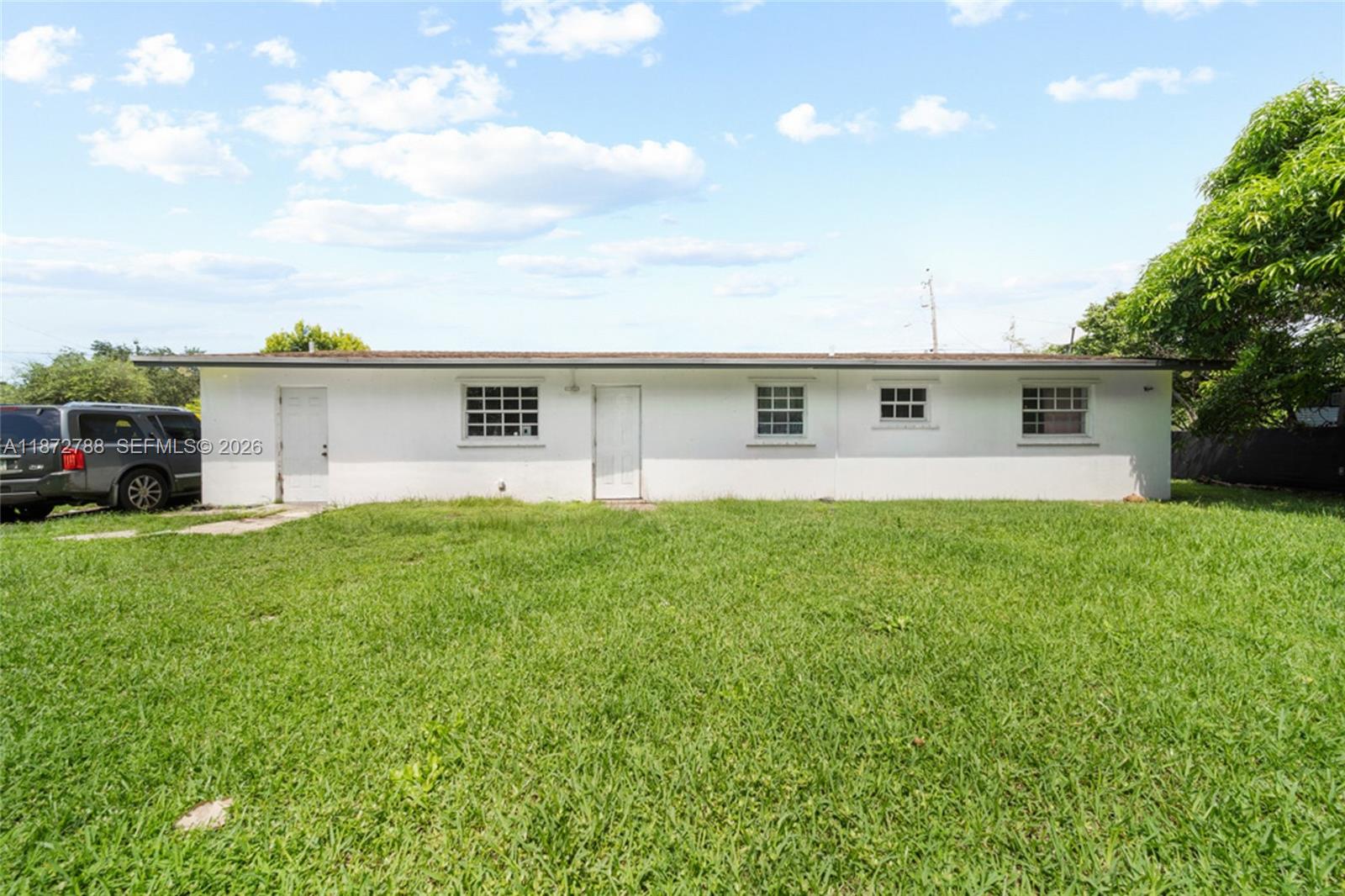 10440 Southwest 178th Street Miami, FL 33157 - Photo 28 of 30 a front view of house with yard