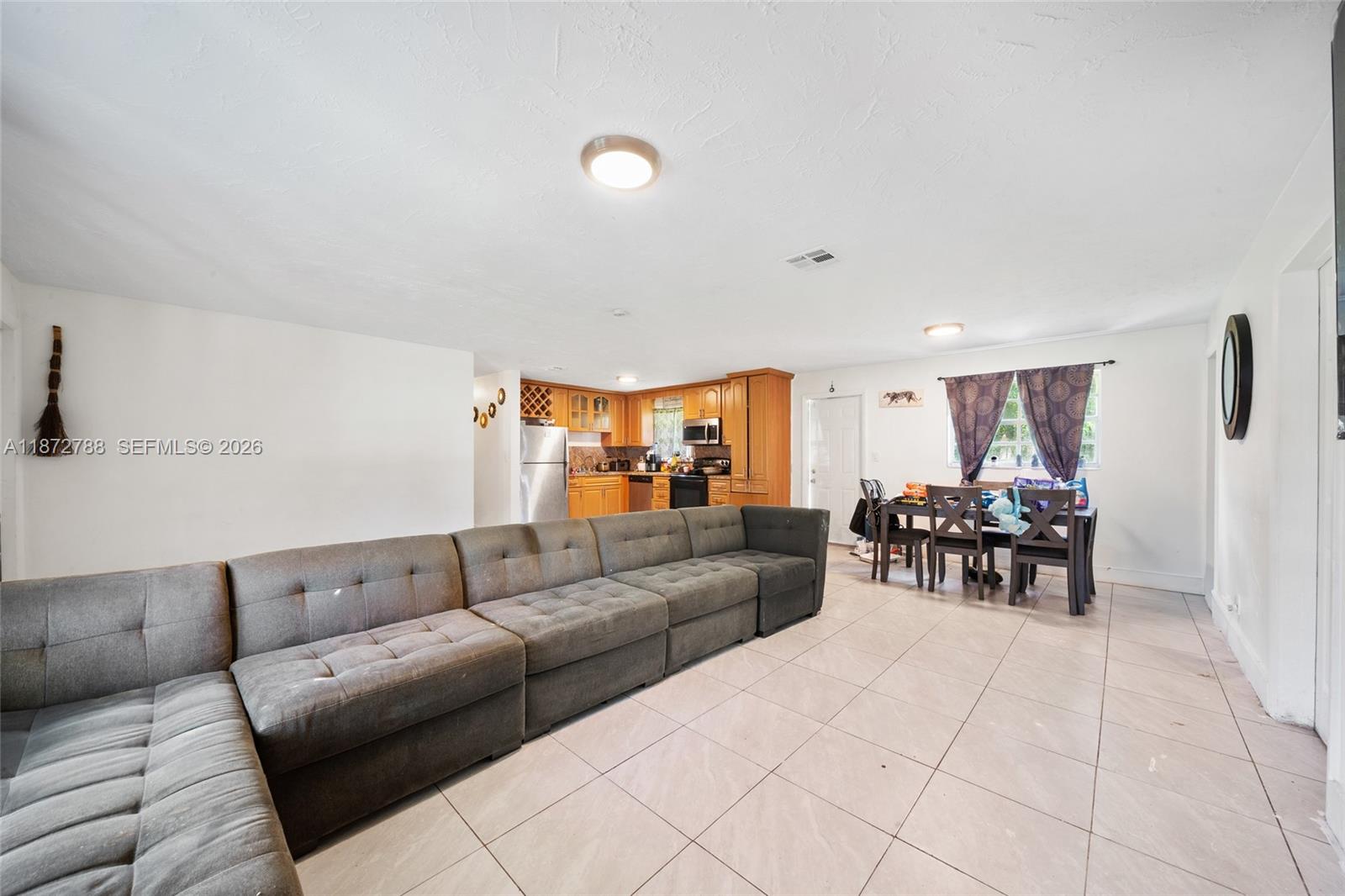10440 Southwest 178th Street Miami, FL 33157 - Photo 3 of 30 a living room with furniture and white walls