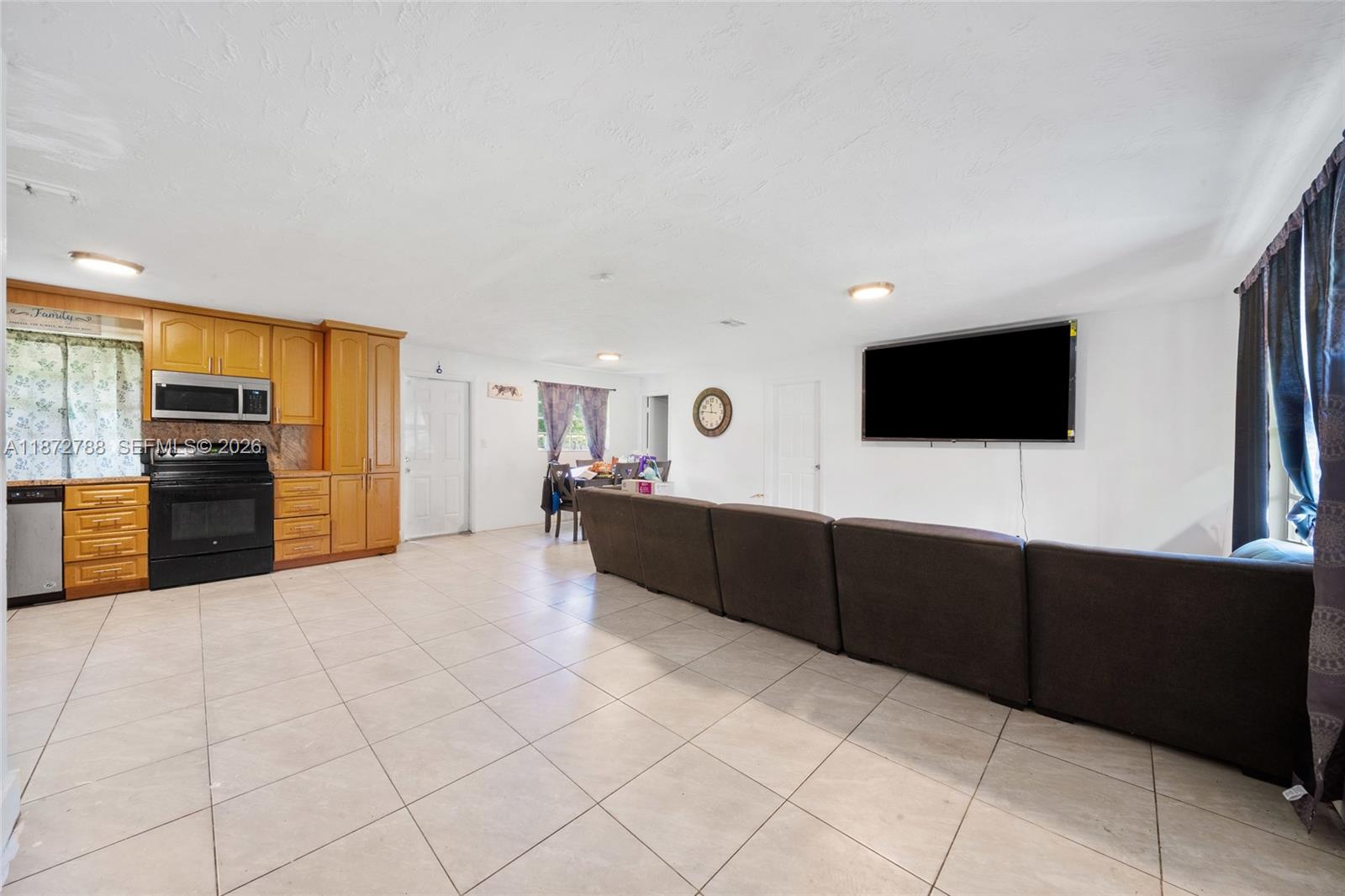 10440 Southwest 178th Street Miami, FL 33157 - Photo 4 of 30 a kitchen with stainless steel appliances a refrigerator and a microwave