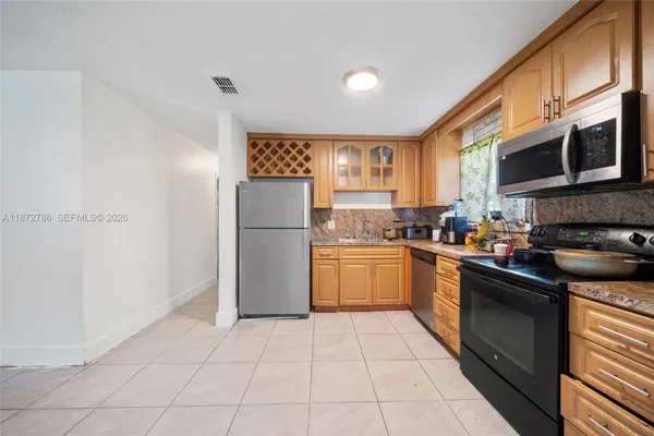 a kitchen with a refrigerator and a sink