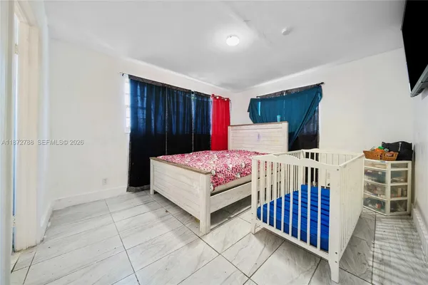 a bedroom with a bed and flat screen tv