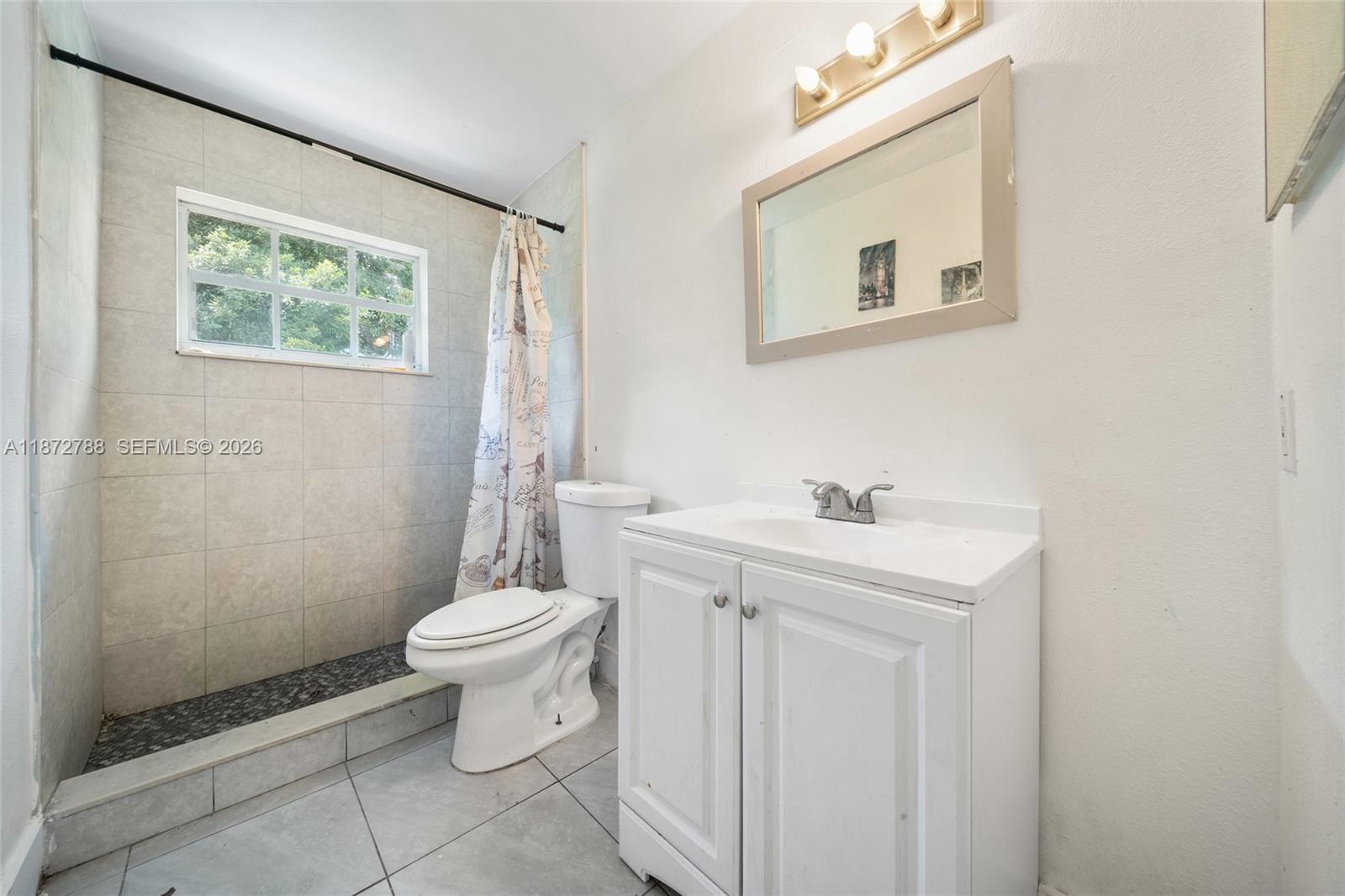 10440 Southwest 178th Street Miami, FL 33157 - Photo 10 of 30 a bathroom with a sink a toilet and a mirror