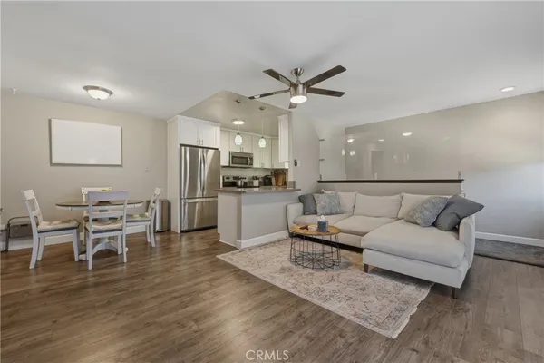 a living room with furniture and kitchen view
