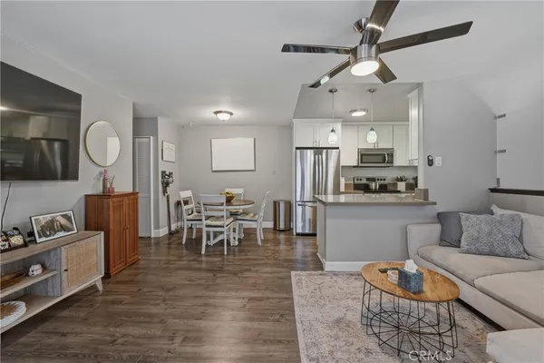 a living room with furniture kitchen view and a dining table