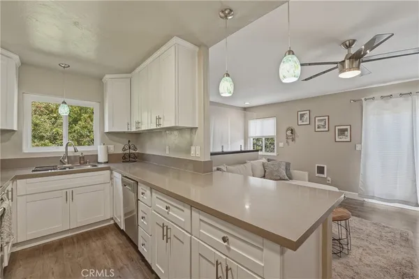 a kitchen with a white cabinets sink and dishwasher