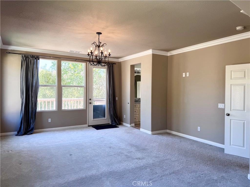 28463 Cascade Road Castaic, CA 91384 - Photo 24 of 29 a view of a big room with windows and chandelier fan