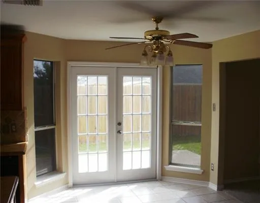 a view of a livingroom with a ceiling fan and window