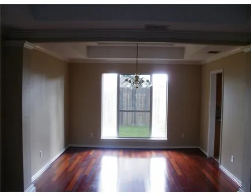 a view of a room with window and wooden floor