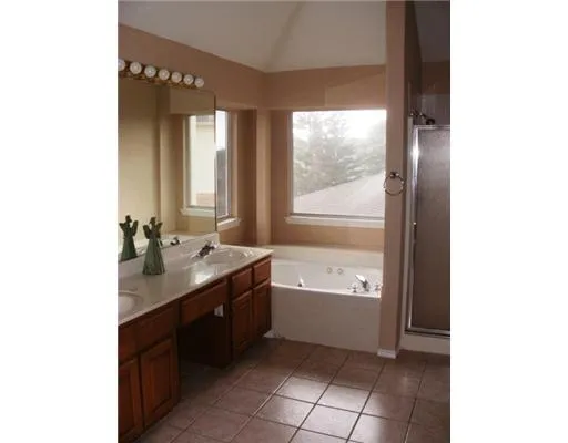 a bathroom with a bathtub sink and mirror