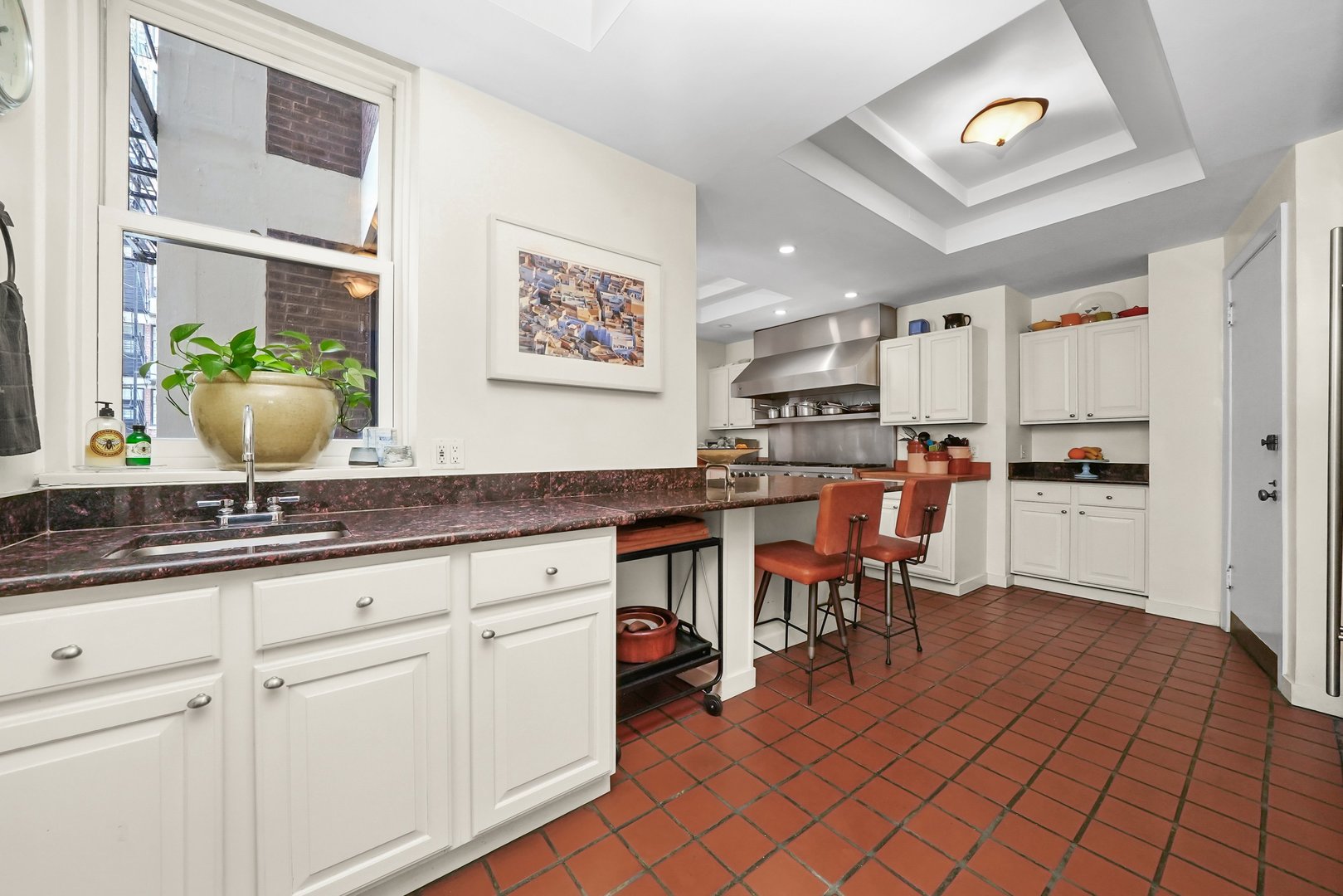 232 East Walton Place, Unit 3W Chicago, IL 60611 - Photo 33 of 50 a open kitchen with granite countertop a sink cabinets and stainless steel appliances