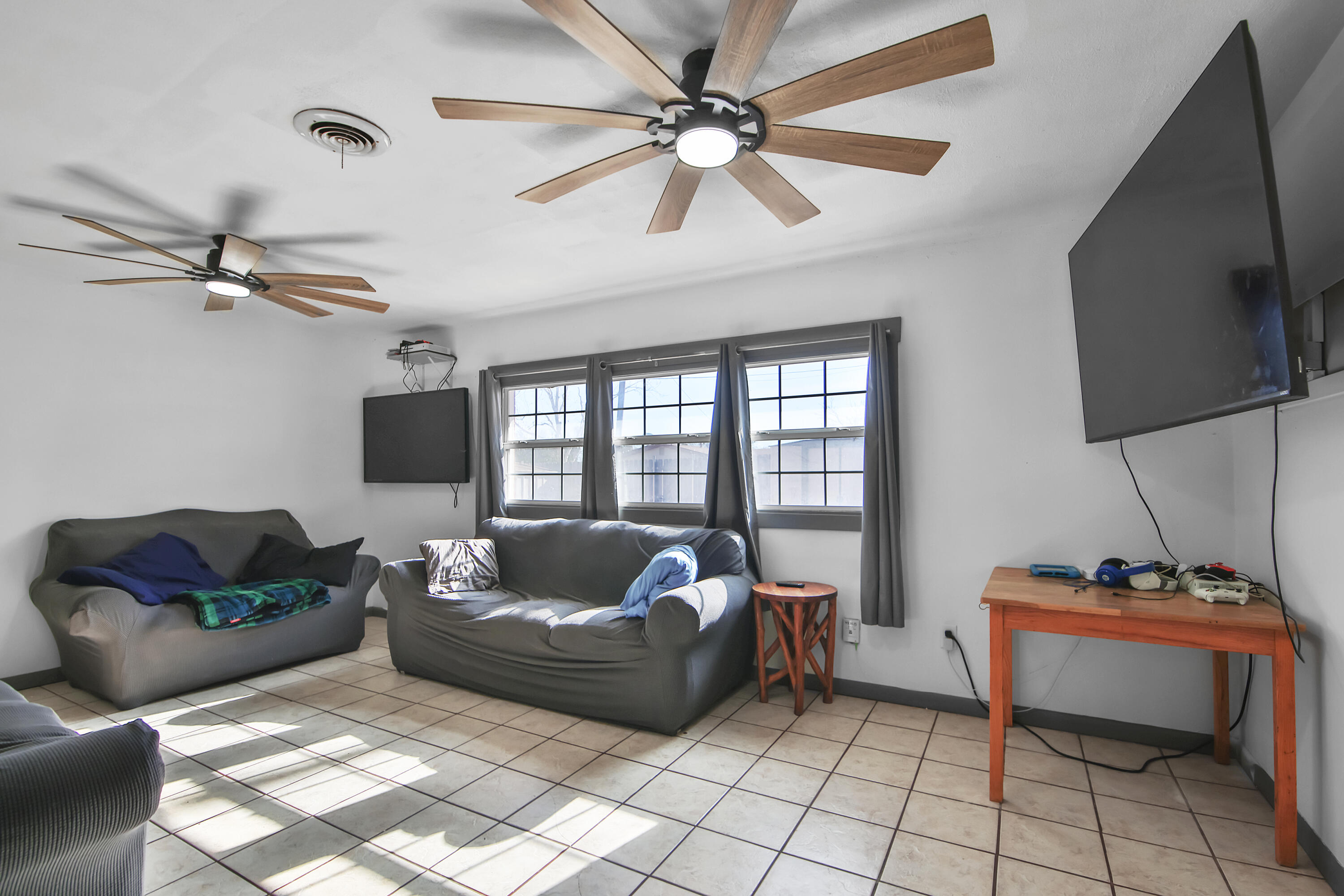 2801 52nd Street Lubbock, TX 79413 - Photo 12 of 34 a living room with furniture and a flat screen tv
